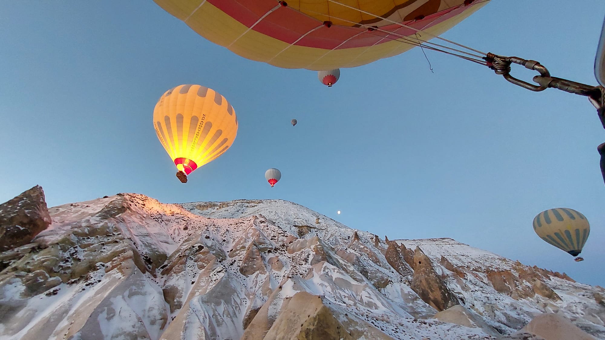 Looking up at hot air balloons against Cappadocia mountains